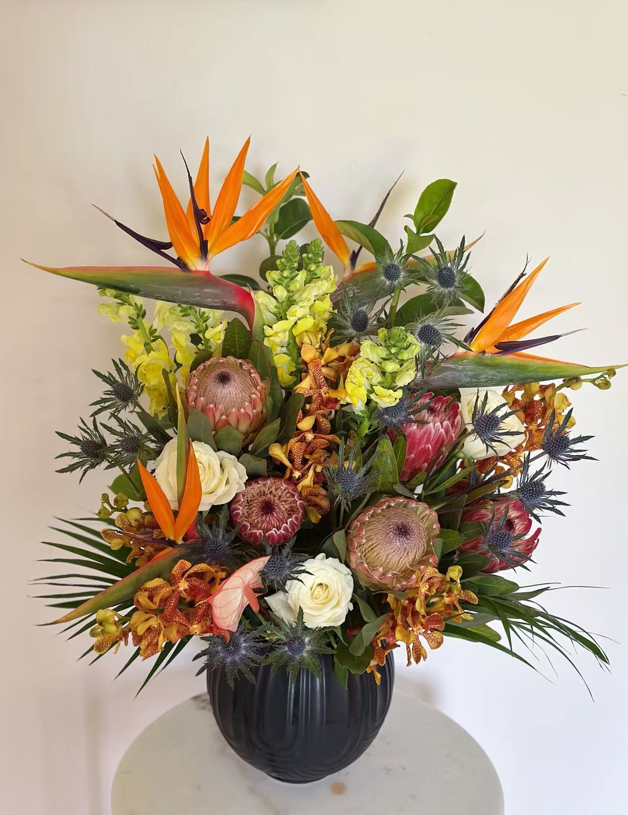 Wild Australia Flower Vase with bird of paradise, protea, orange orchids, sea holly, white roses, snapdragons and tropical foliage | Pisces Flower Melbourne